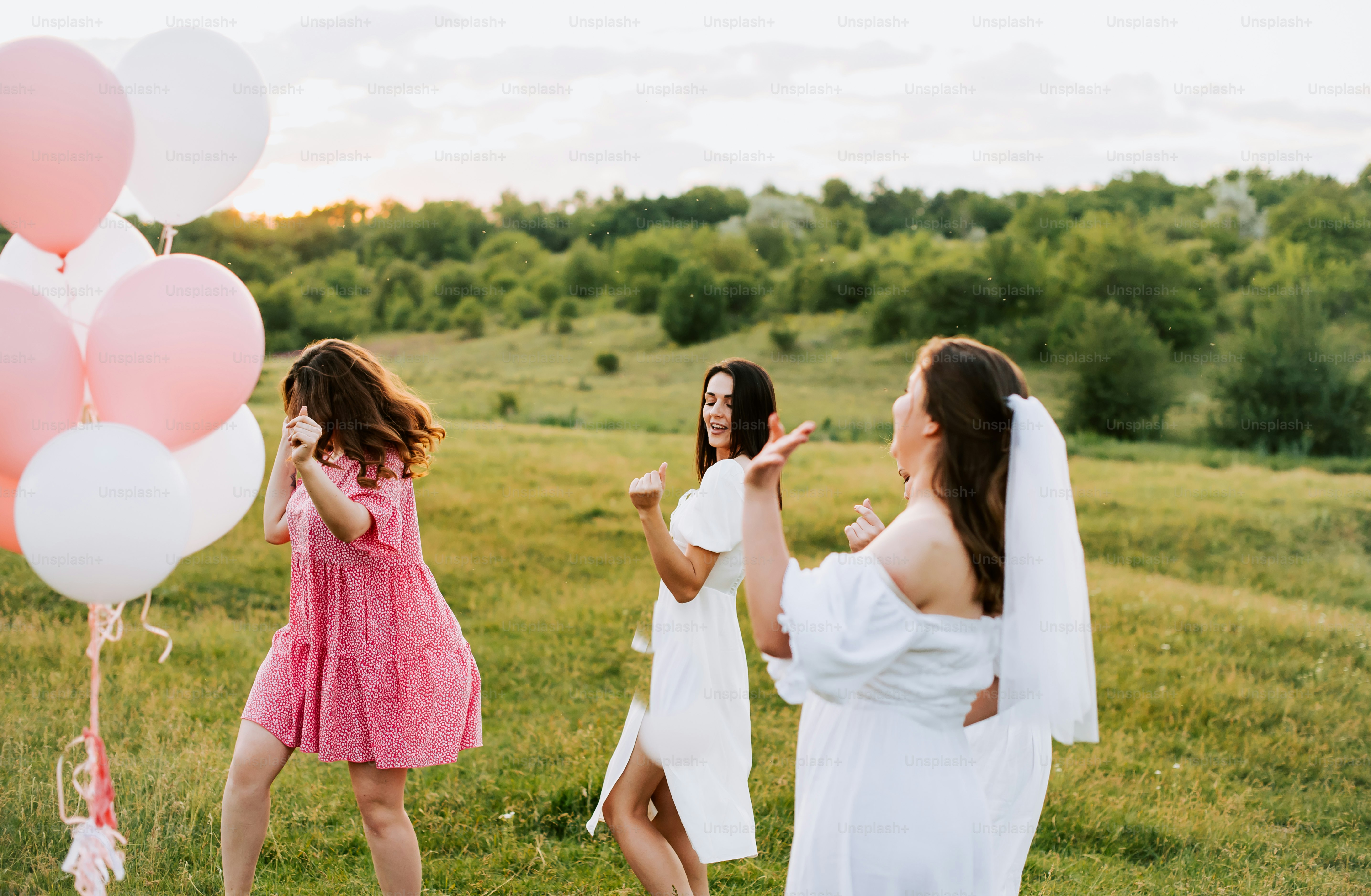 a group of women standing on top of a lush green field