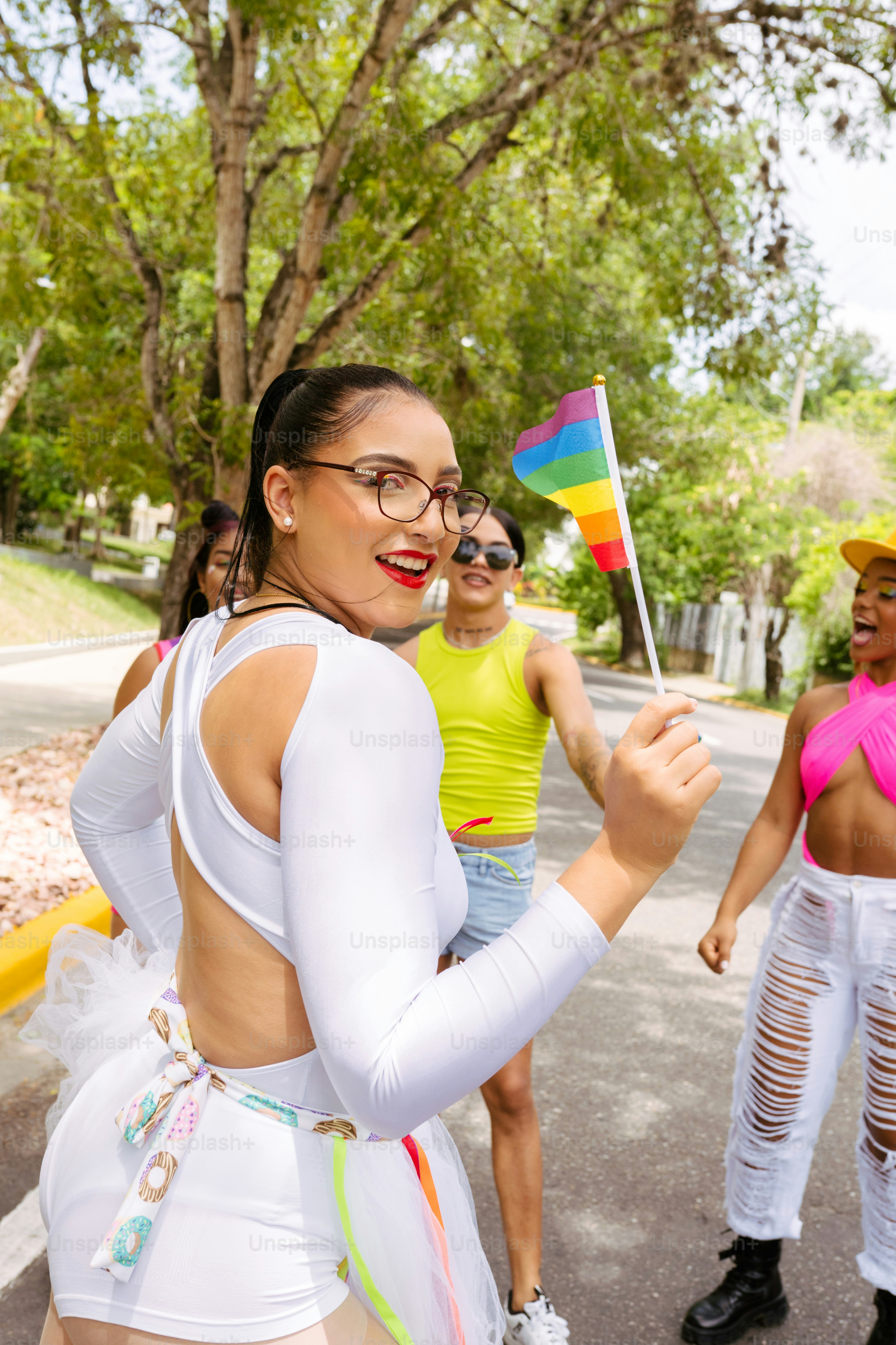 a group of women walking down a street holding a flag