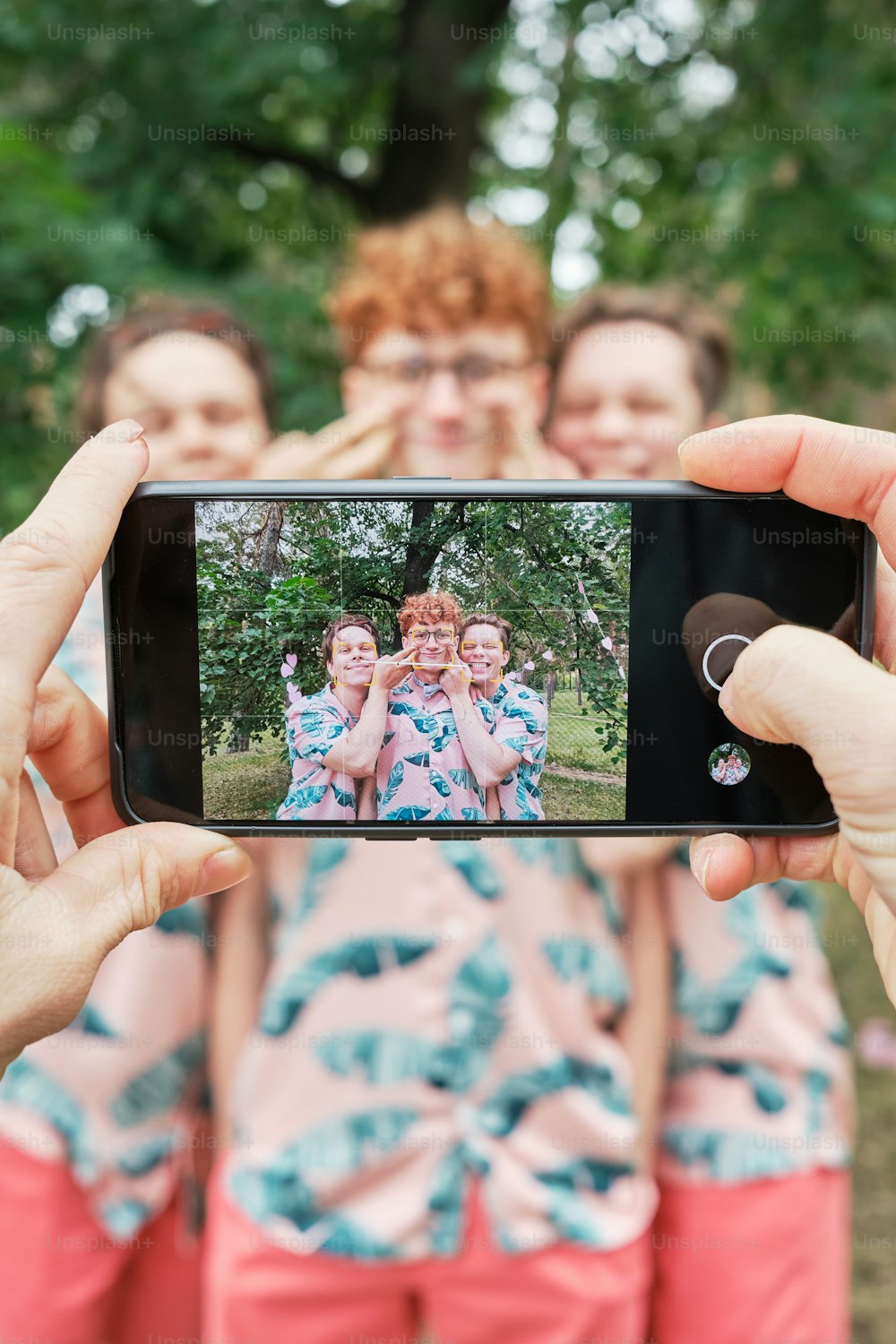a group of women taking a picture with a cell phone