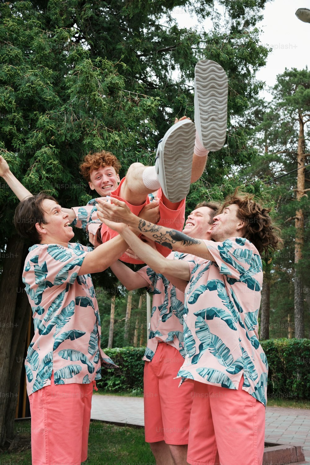 a group of young men standing next to each other holding a frisbee