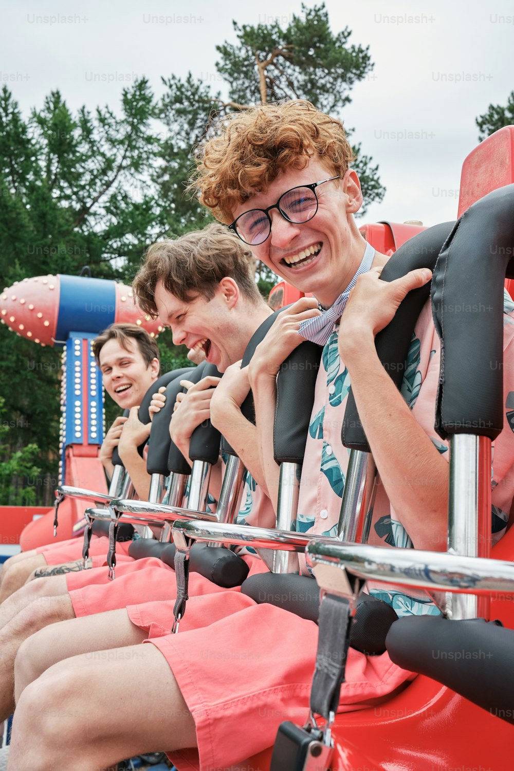 a group of people riding on top of a roller coaster