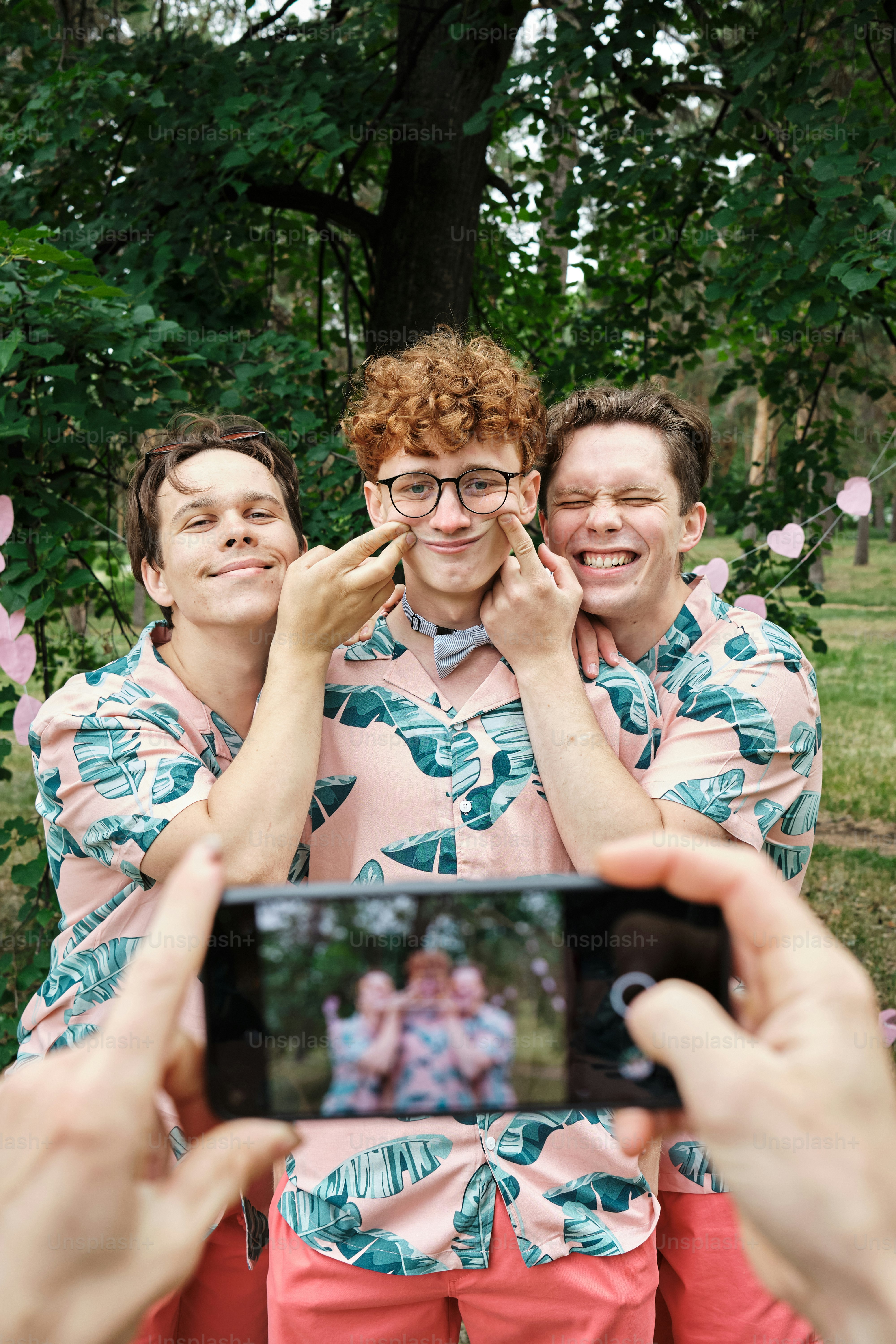 a group of people taking a picture with a cell phone