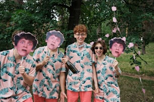 a group of people in matching shirts holding up pictures of themselves
