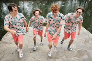 a group of young men walking along a river