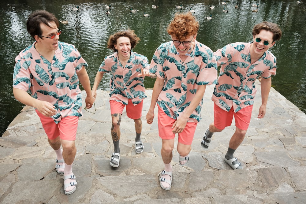 a group of young men walking along a river