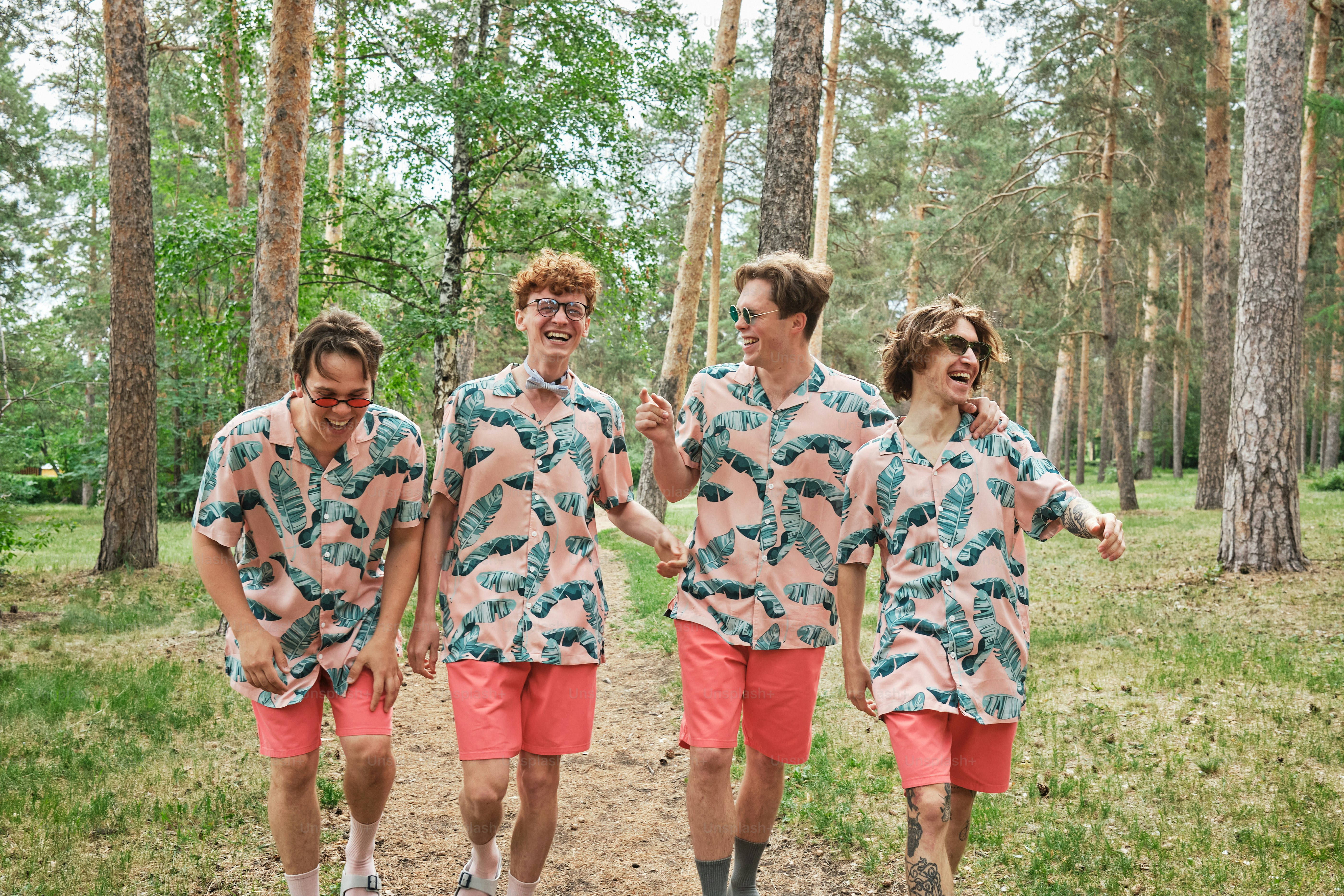 Four friends celebrate a bachelor party outdoors in a park
