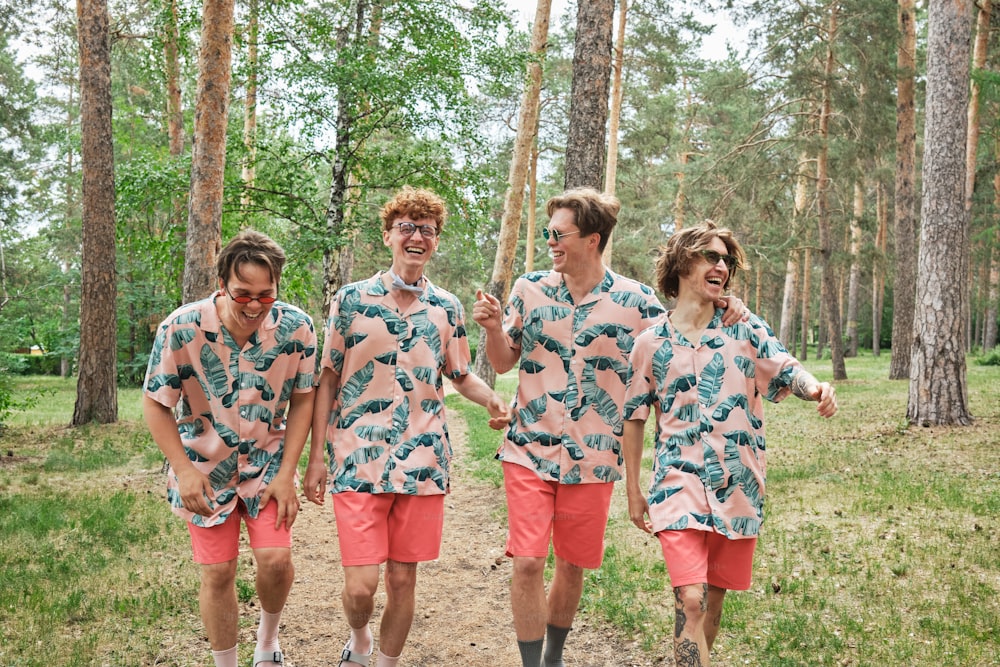 a group of young men walking through a forest
