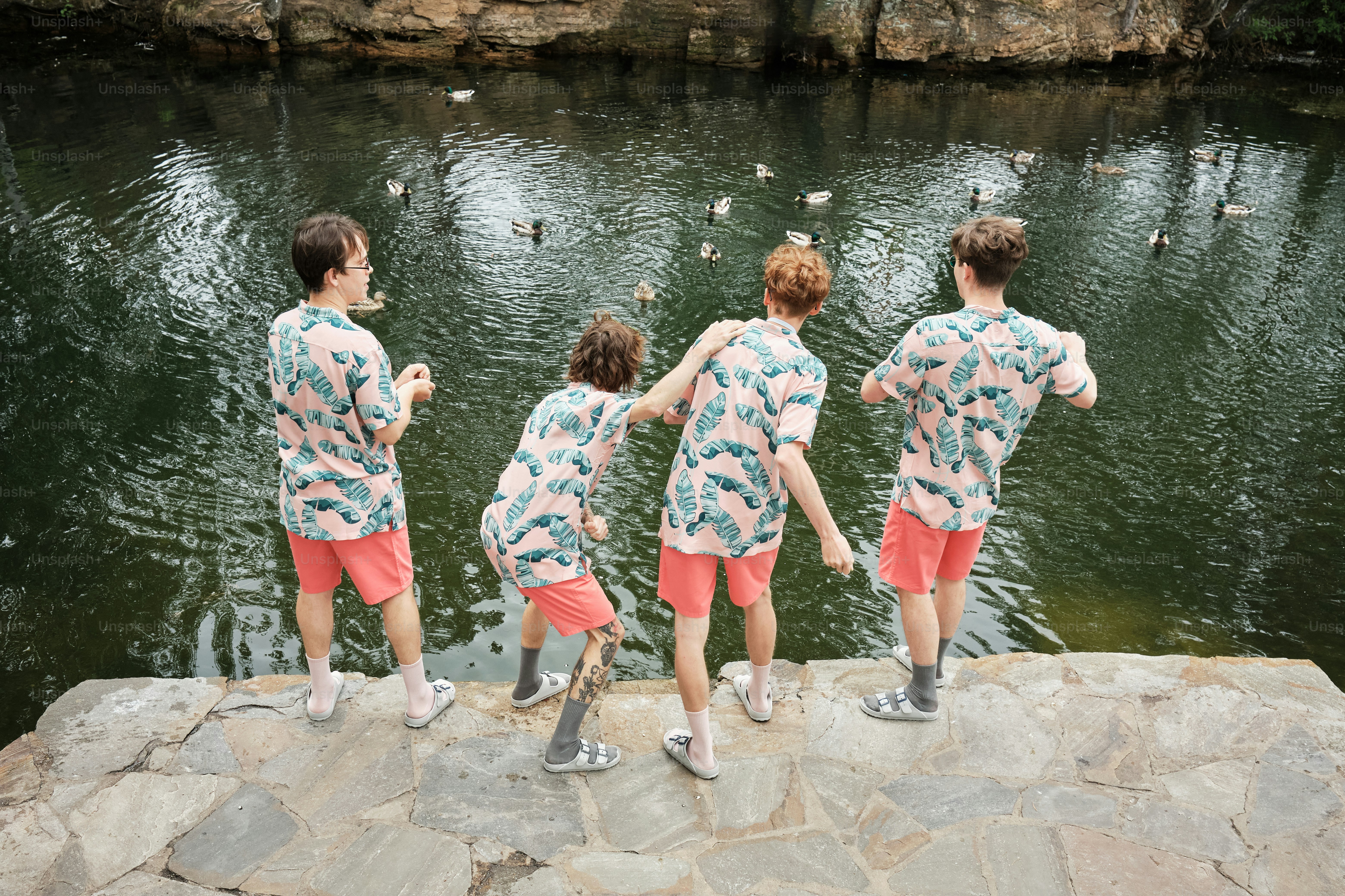 a group of people standing next to a body of water