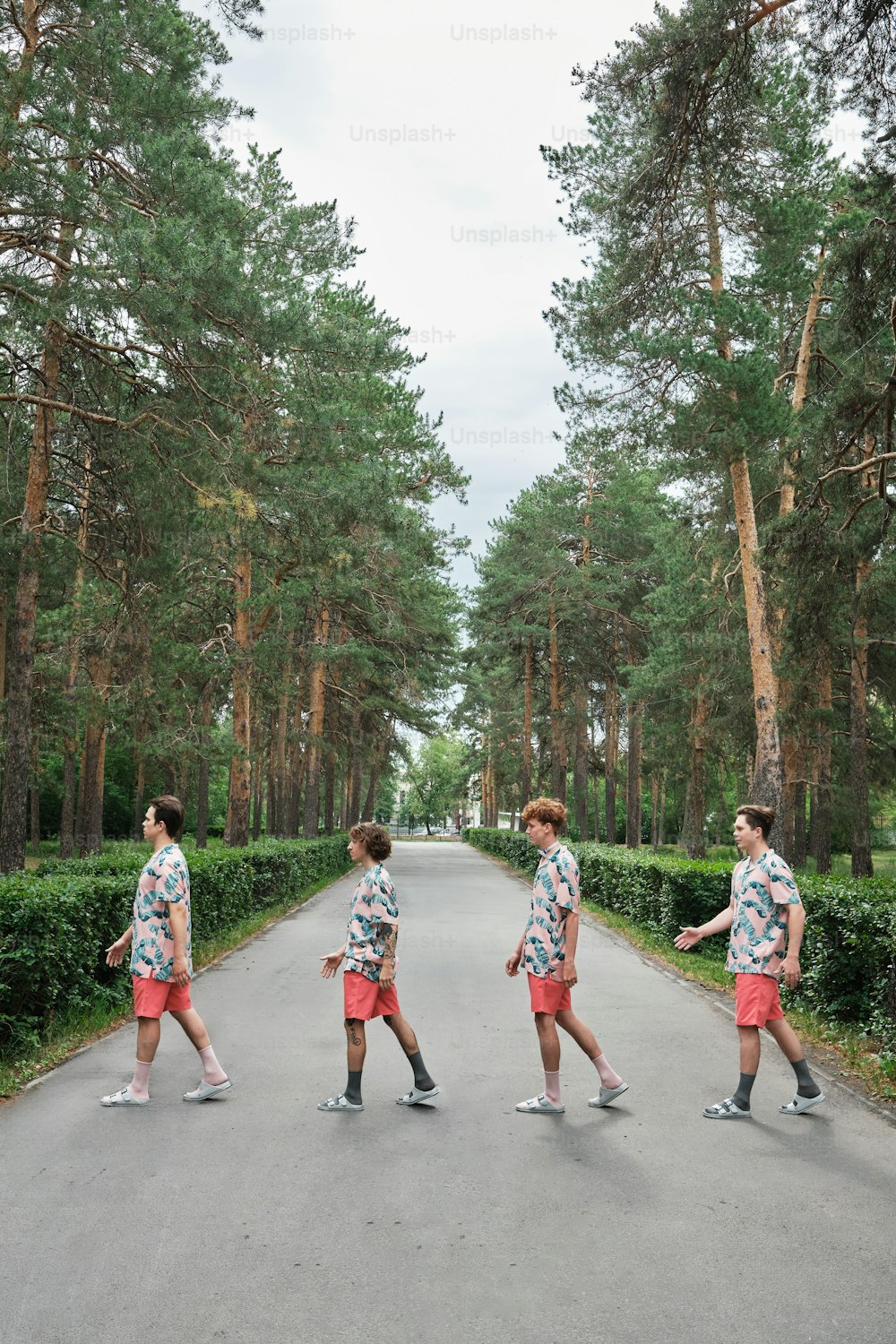 a group of young men walking down a road