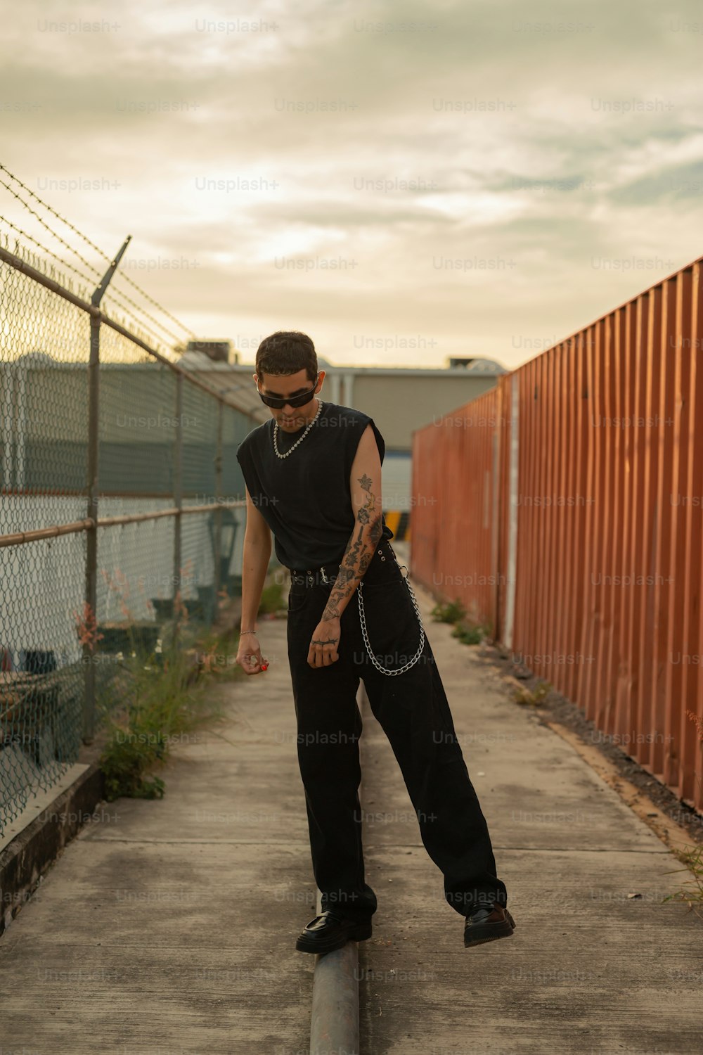 a man standing on top of a metal pole