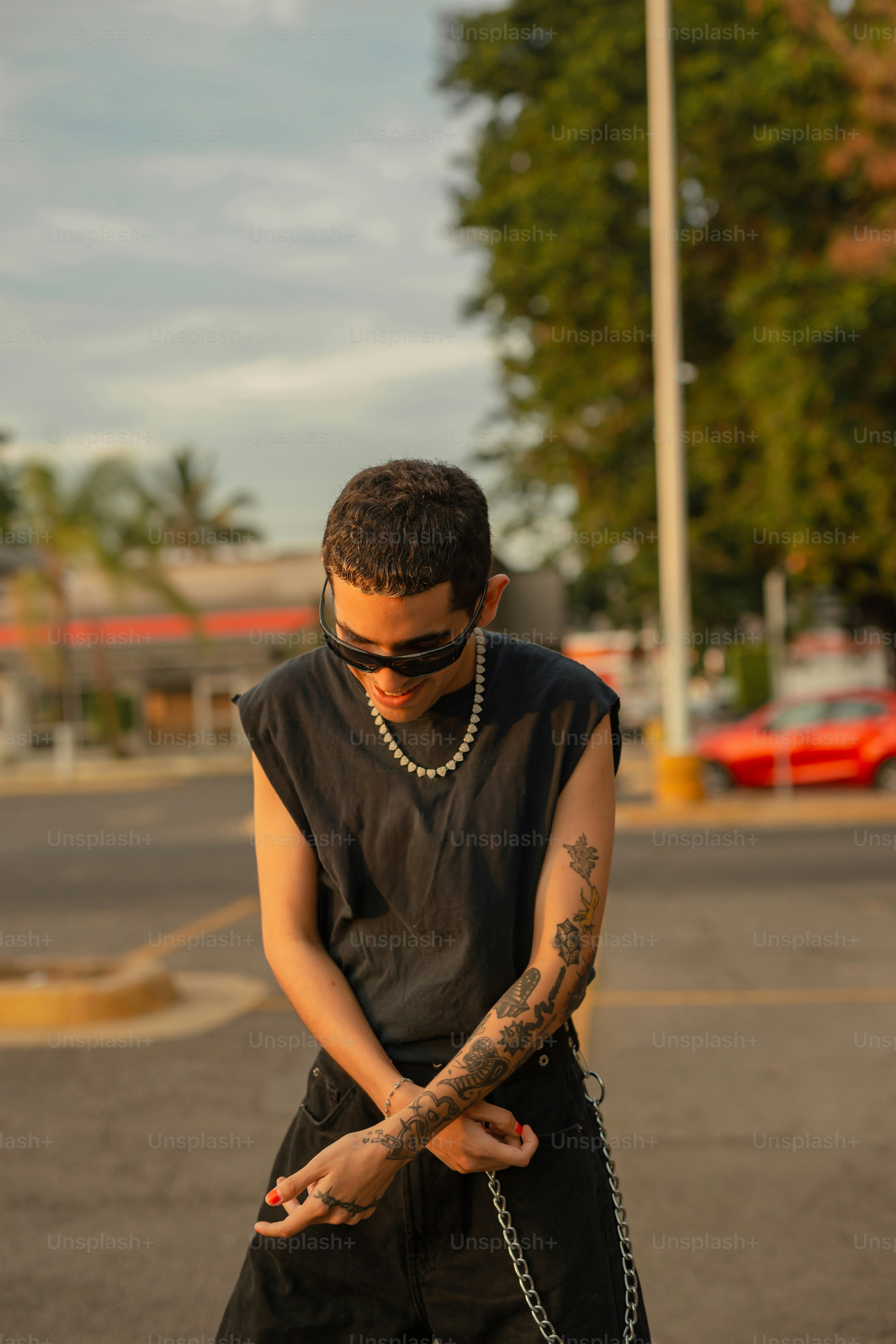 a man with a chain around his neck on a skateboard