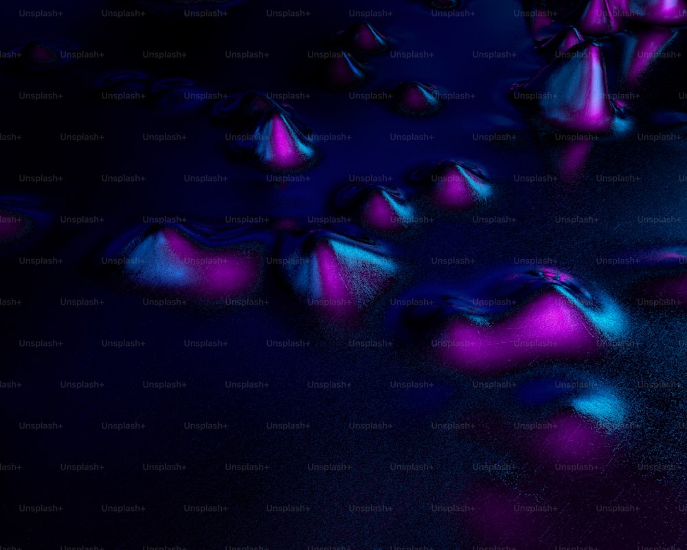 Un grupo de bolas rosadas y azules sobre una superficie negra