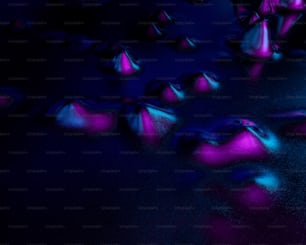 eine gruppe von rosa und blauen kugeln auf einer schwarzen oberfläche