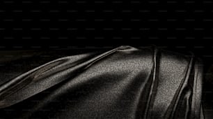 un gros plan d’un tissu noir avec un fond noir