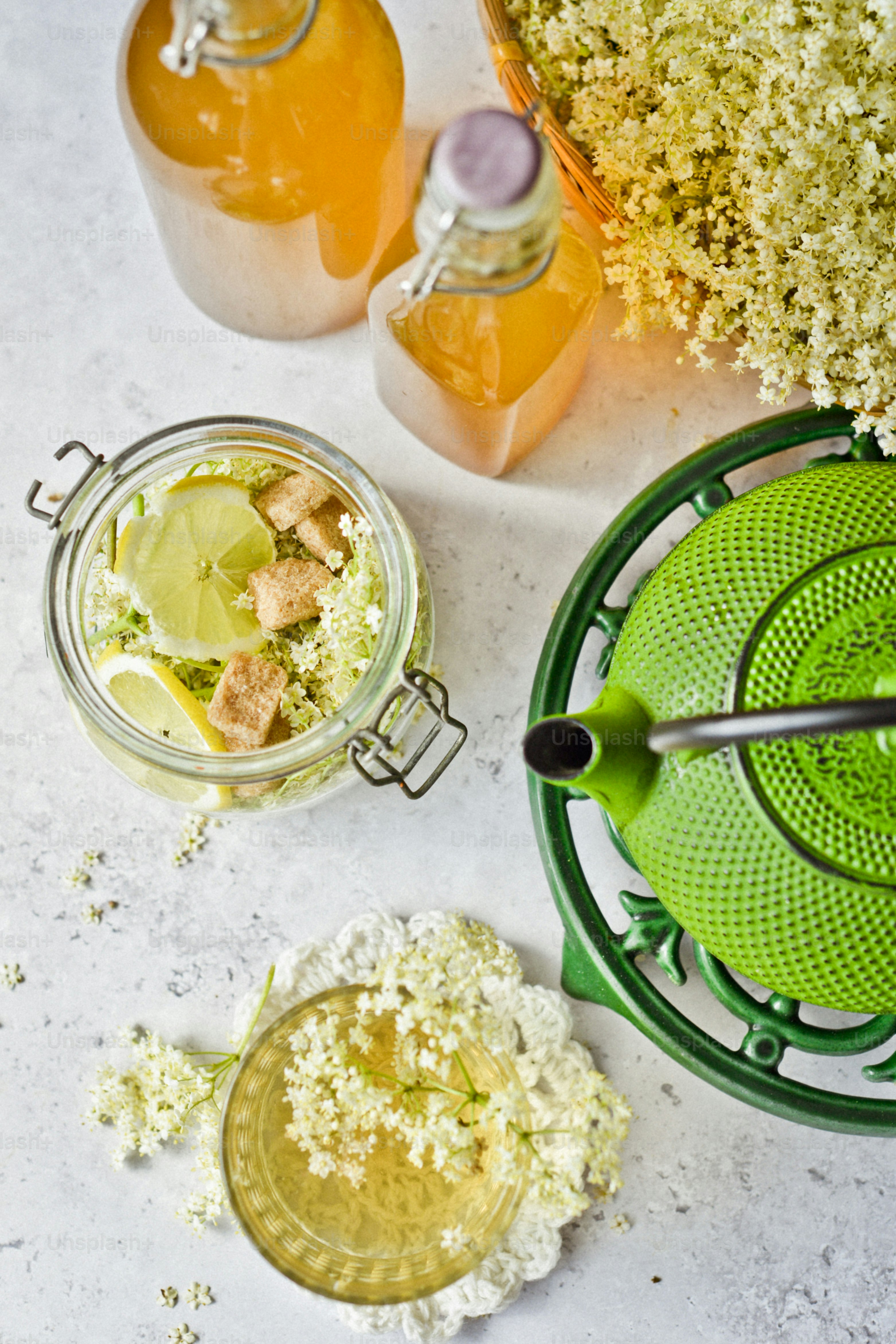 a table topped with jars of liquid and flowers