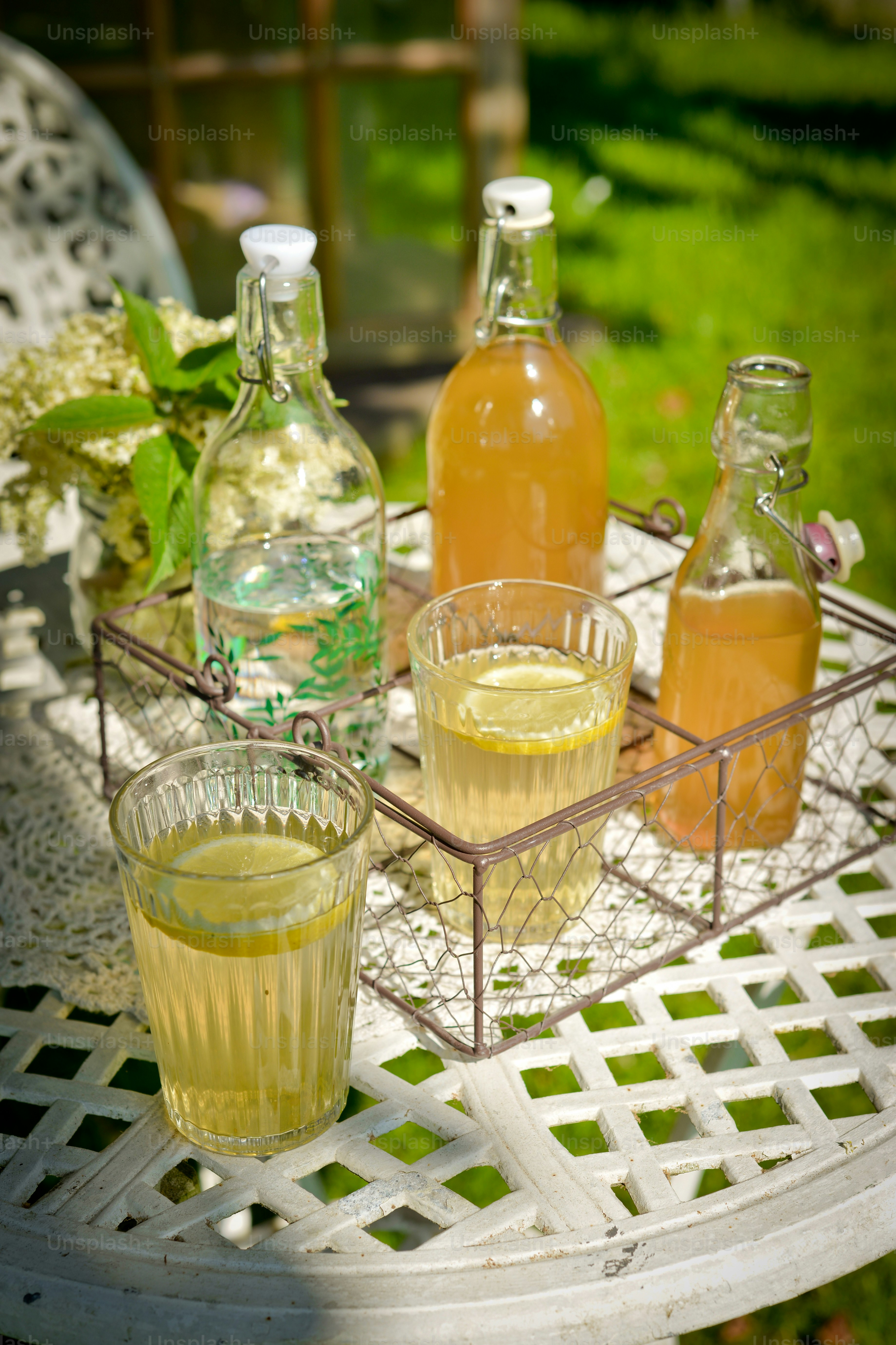 a table topped with glasses and bottles of liquid