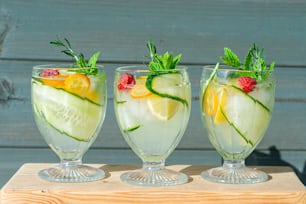 three glasses filled with different types of drinks