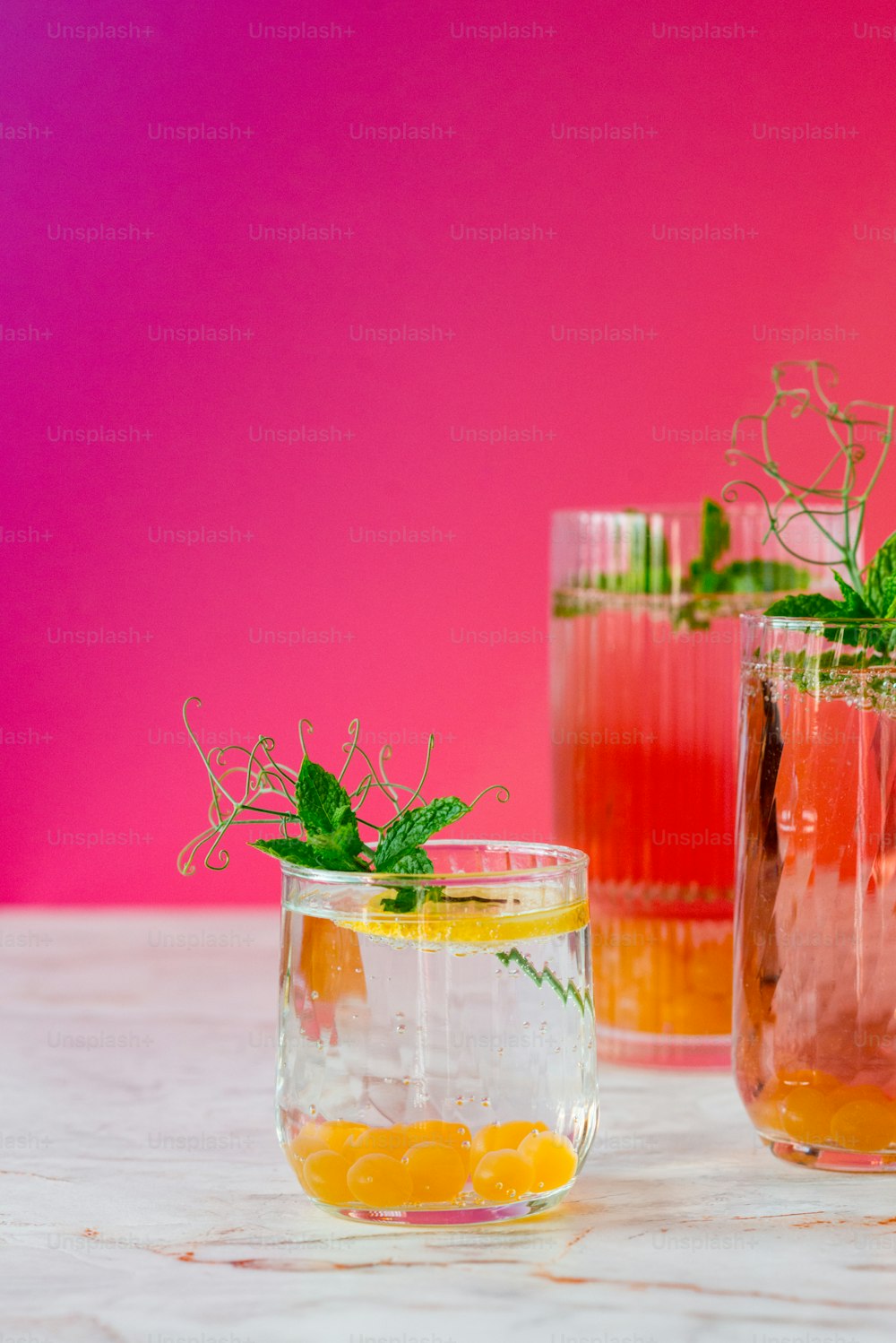 a couple of glasses filled with drinks on top of a table