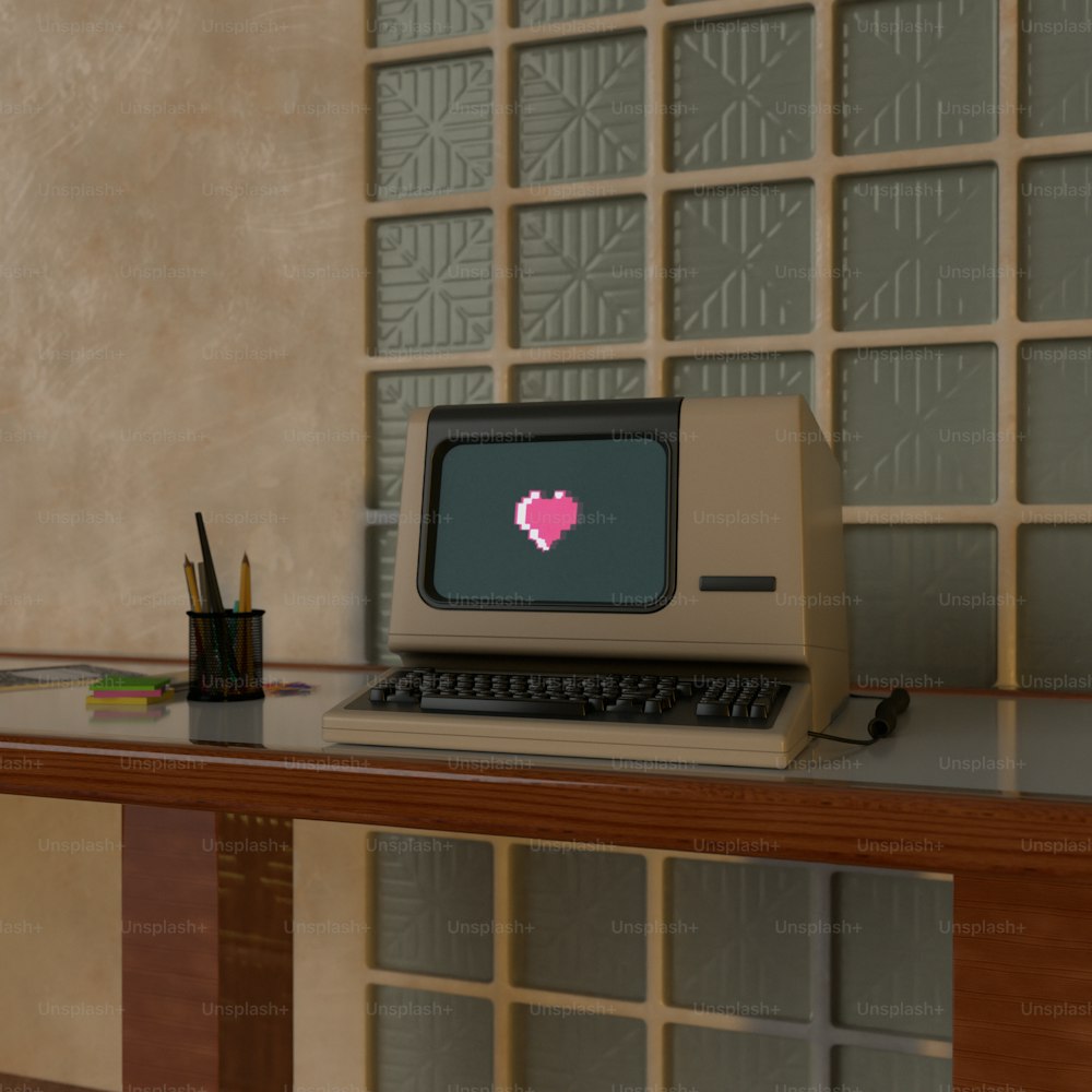 an old computer with a heart on the screen