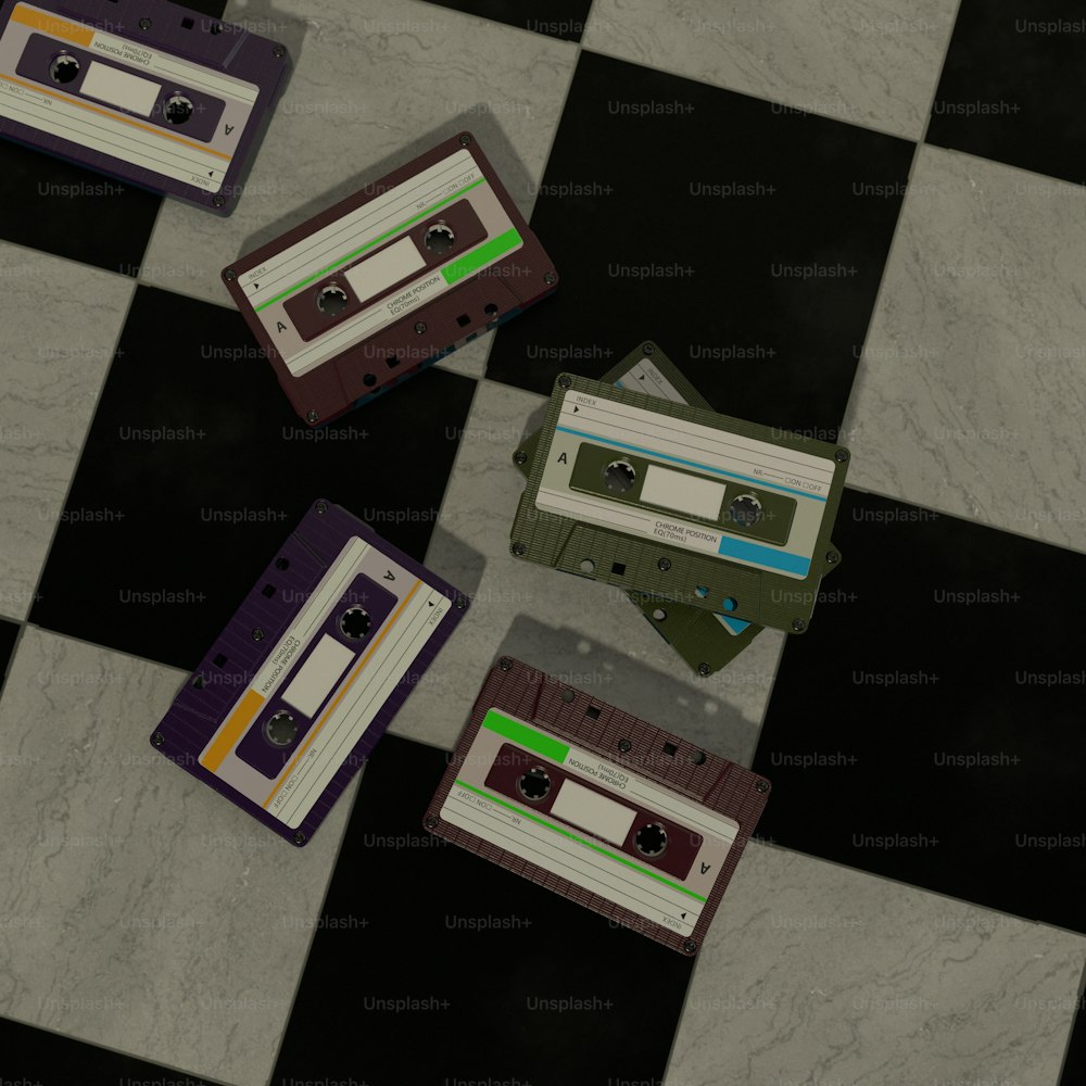 a checkered floor with three old school cassettes laying on top of each other