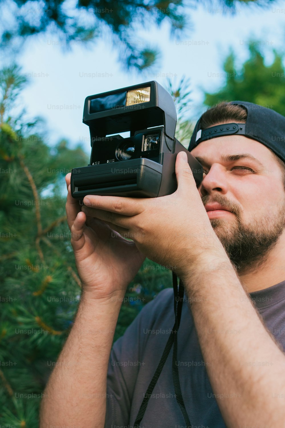 a man holding a camera up to his face