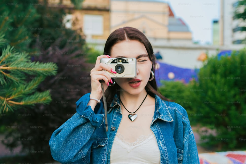 a woman holding a camera up to her face