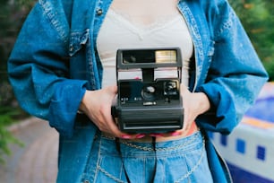 a woman holding a camera in her hands