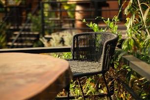 a chair and table sitting on a balcony