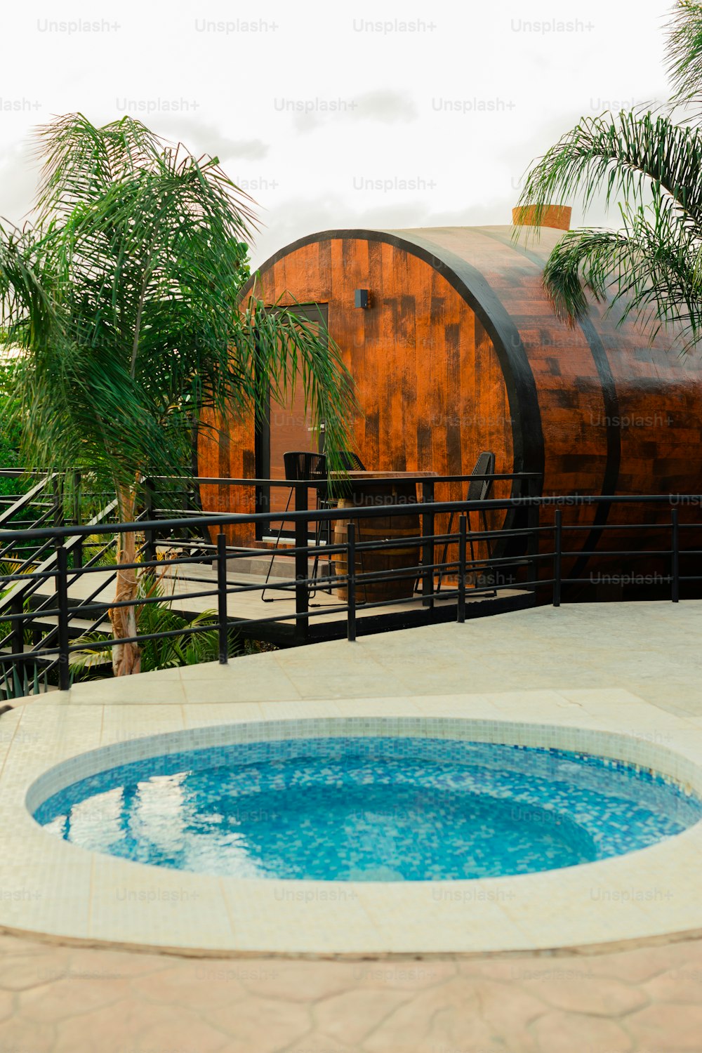 a hot tub sitting next to a wooden barrel