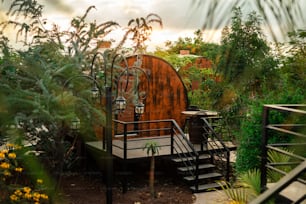 a wooden structure surrounded by plants and trees