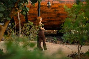 a woman standing in front of a wooden structure