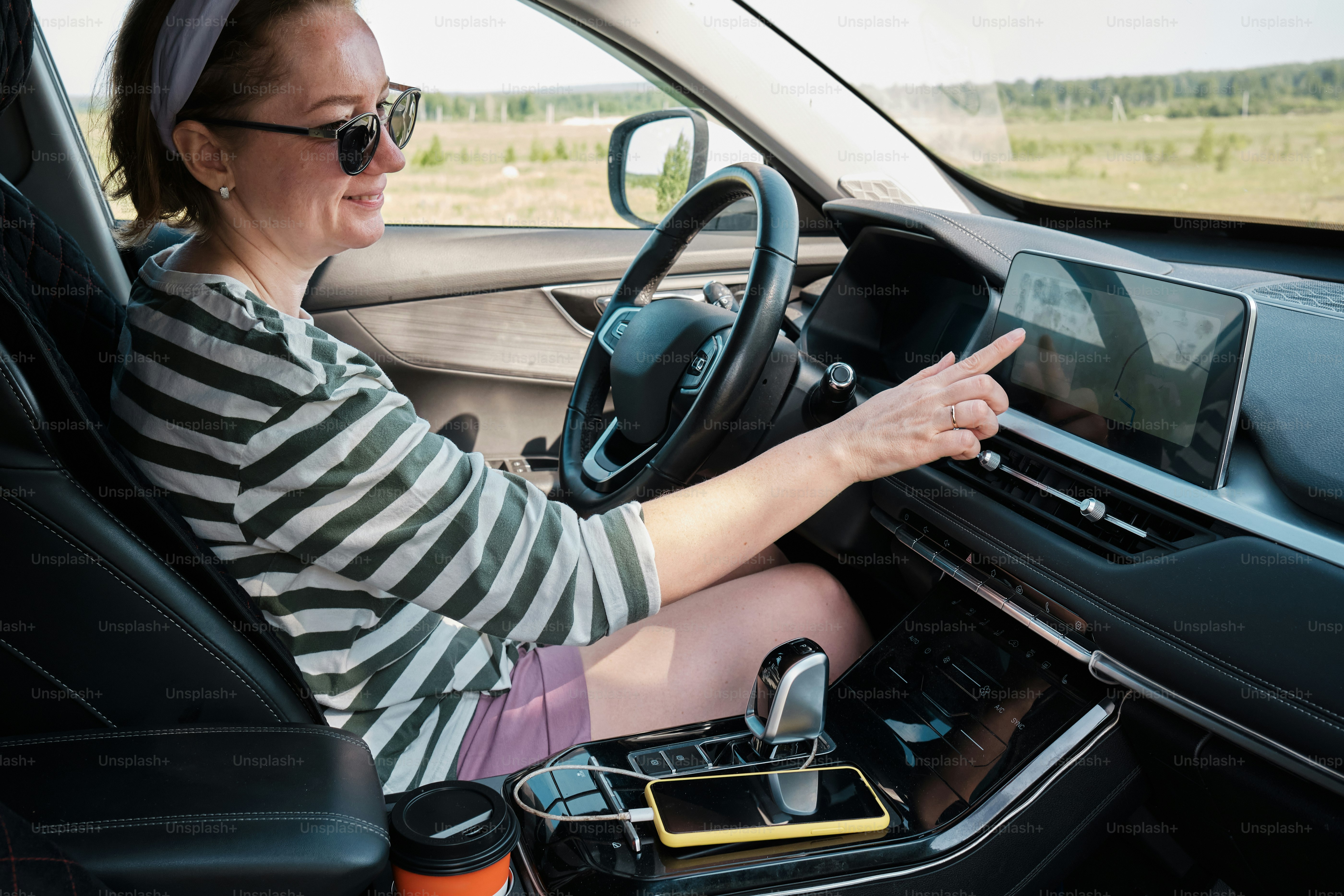 Woman choosing a route on a car navigation device