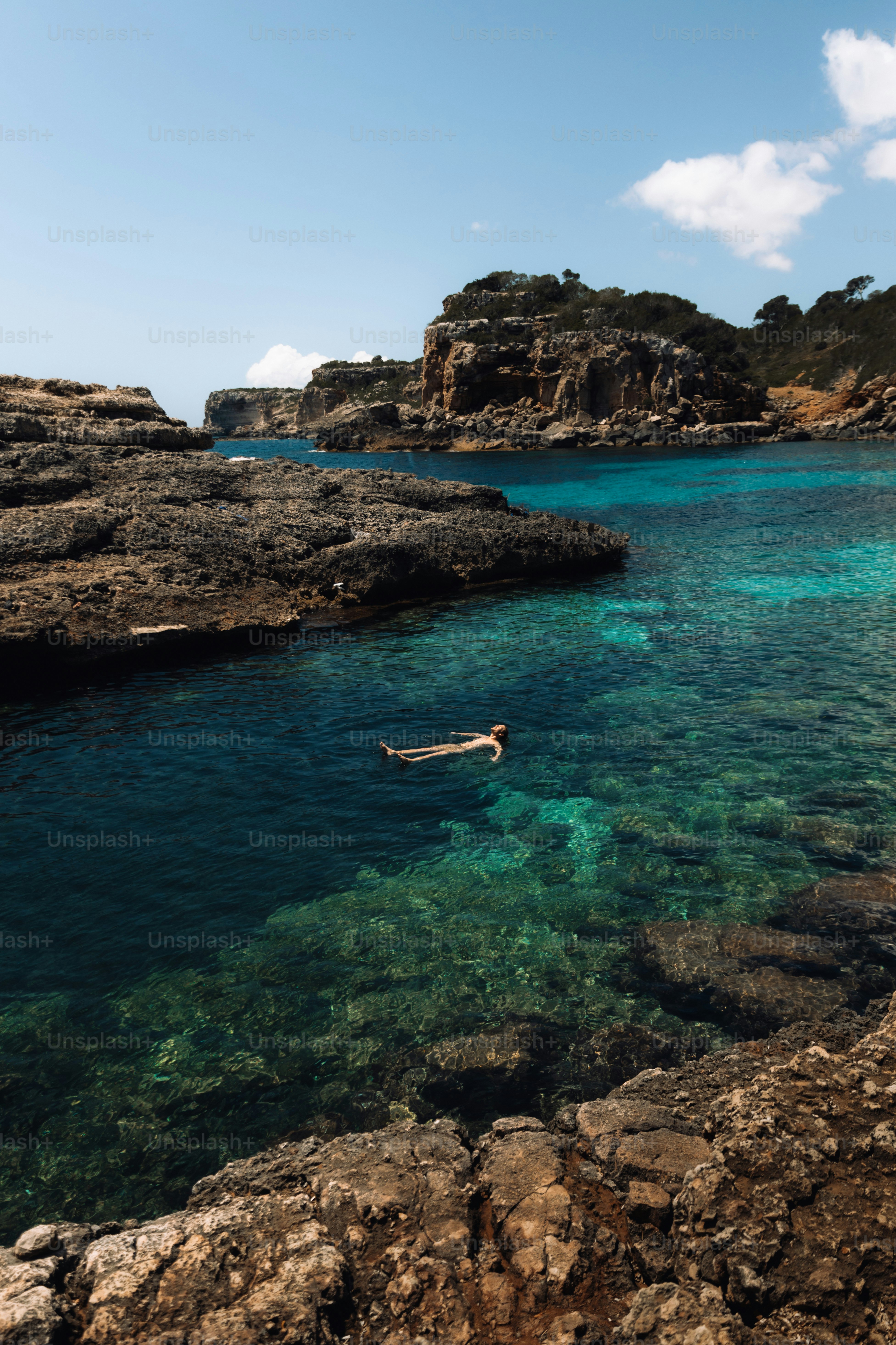 a body of water with a person floating in it