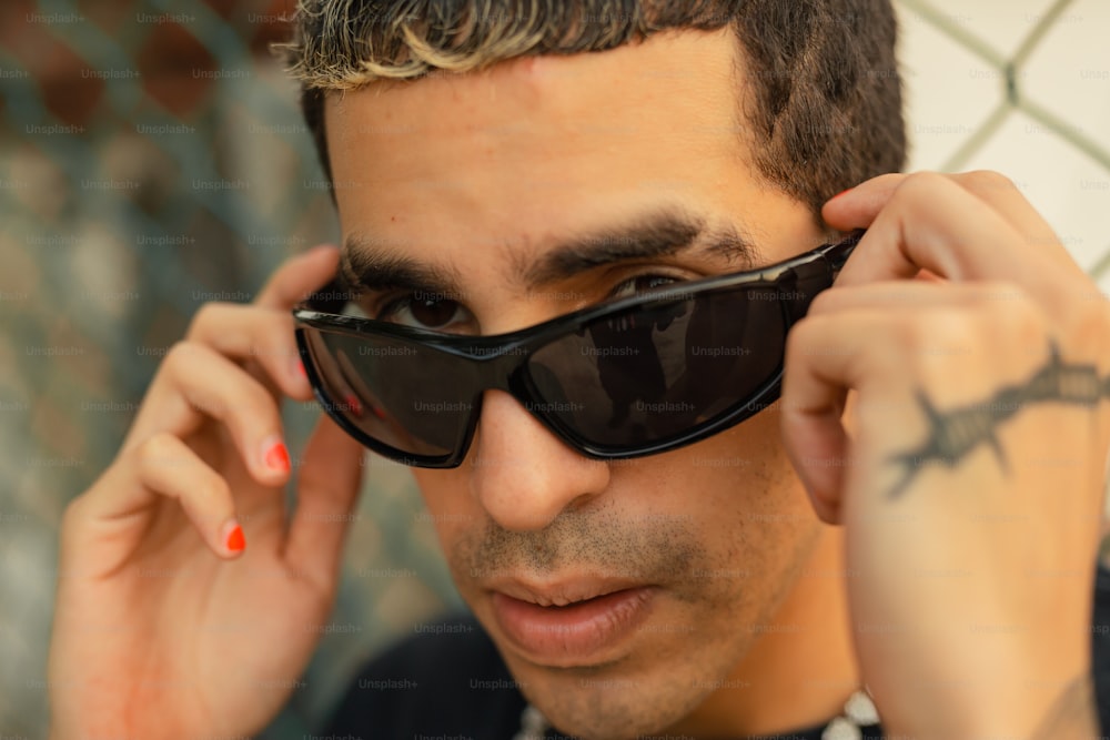 a man wearing a black shirt and sunglasses