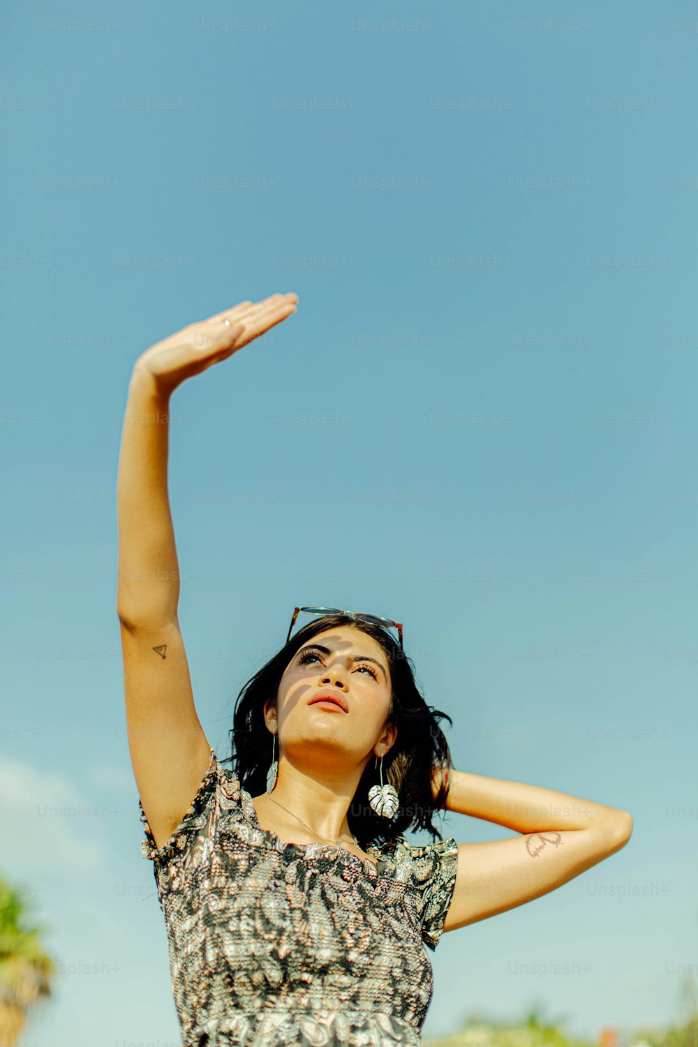a woman is holding her arms up in the air