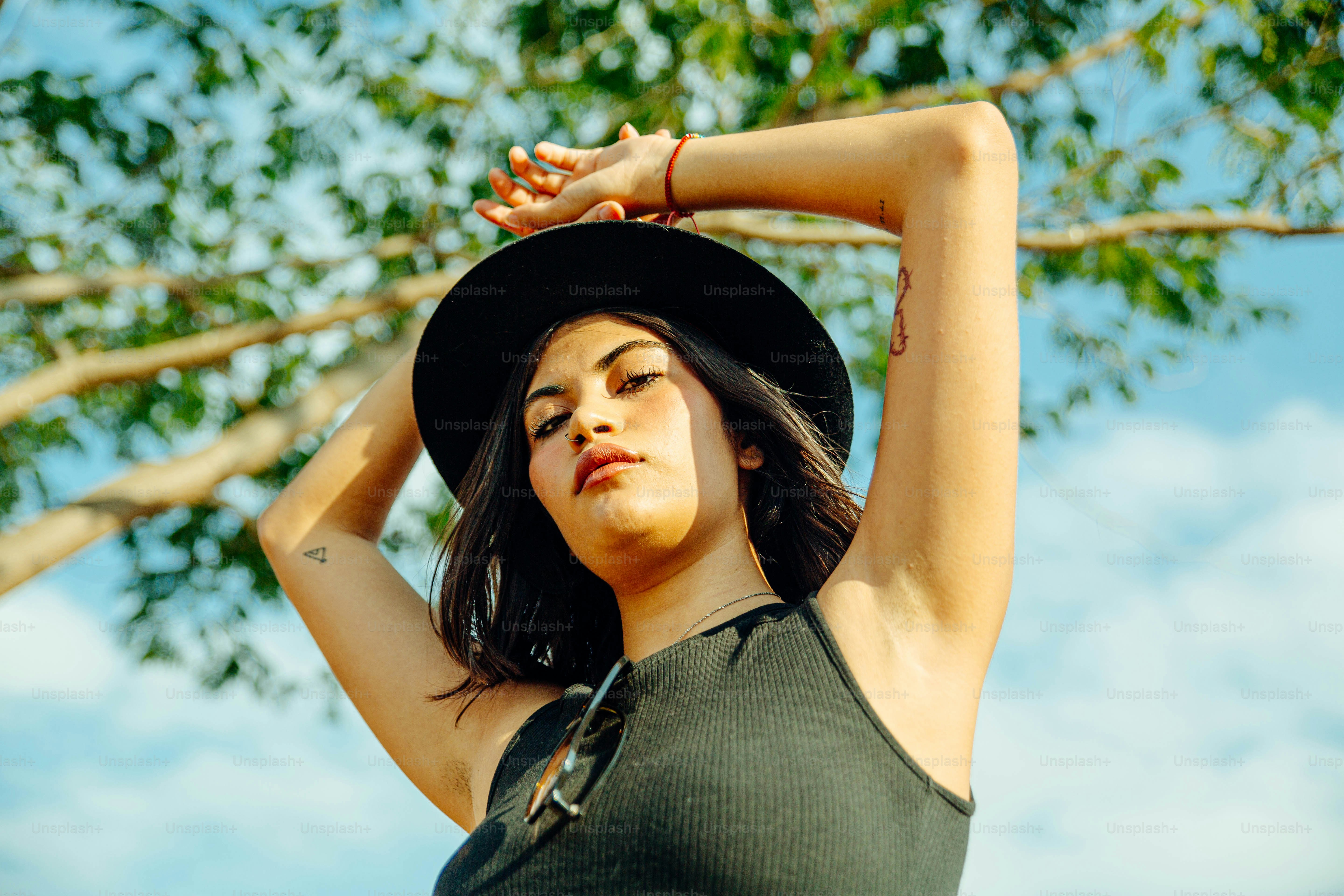 Una mujer con sombrero posa para una foto foto – Imagen de Verano en ...