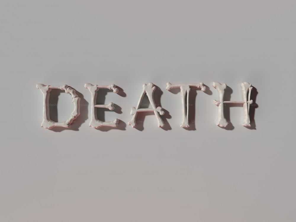 the word death spelled with white frosting on a gray background