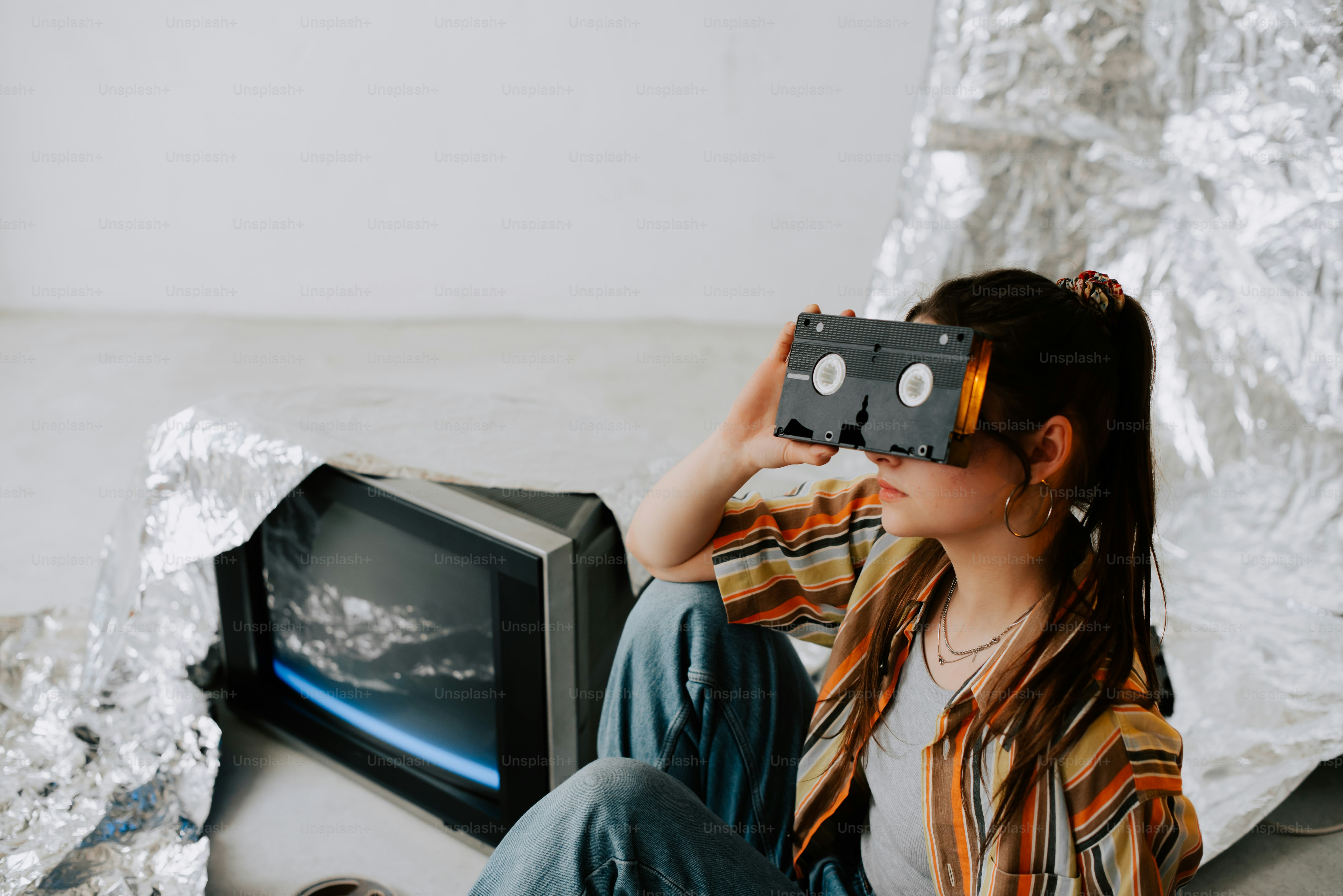 a girl sitting on the floor with a tape recorder in front of her face