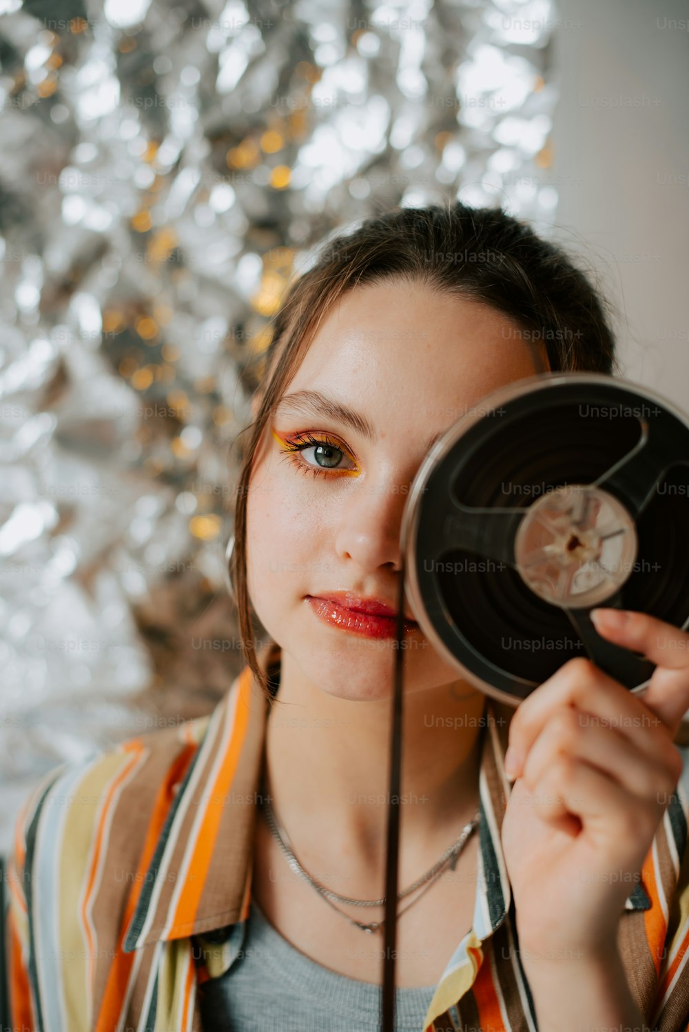 a woman holding a record in front of her face