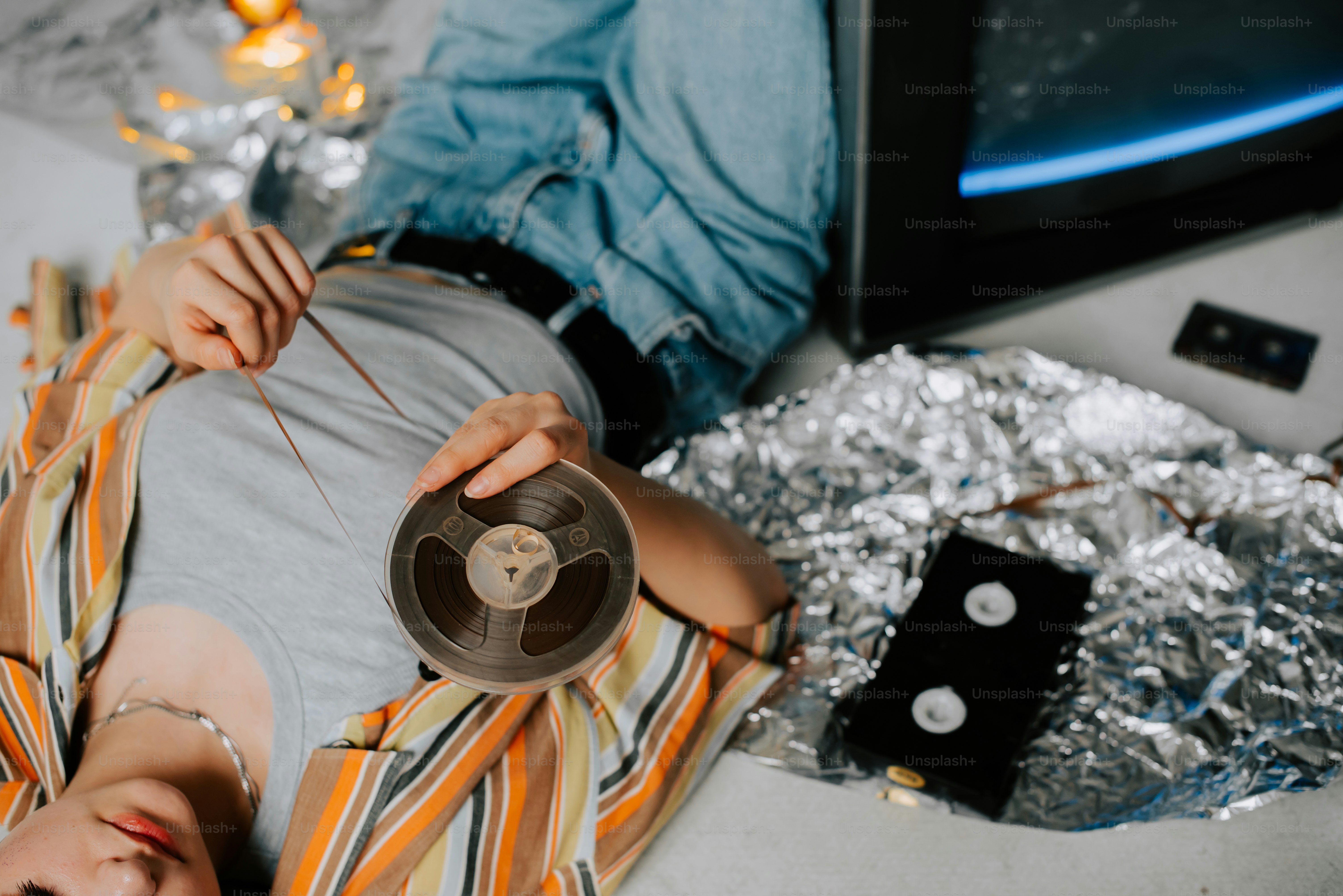 a person laying on the ground holding a piece of tape
