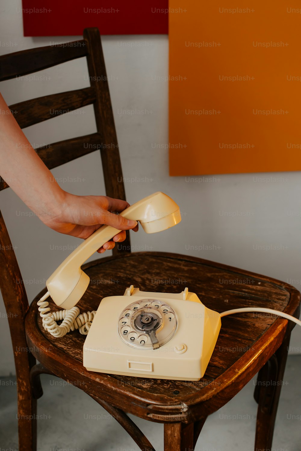 a person is holding a phone to a chair