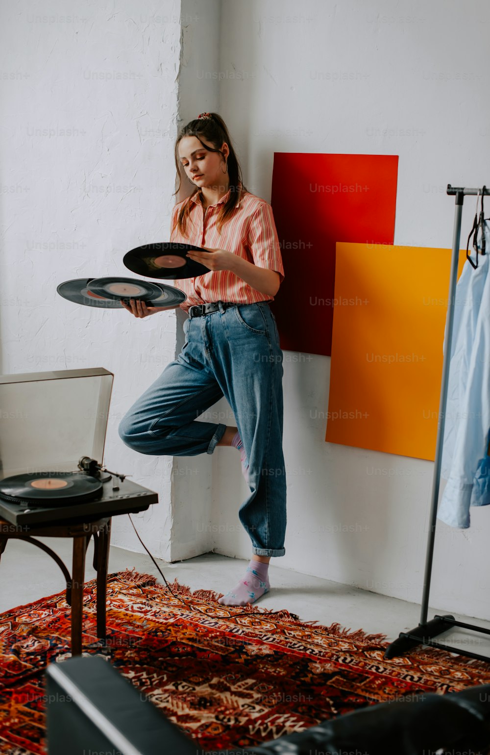 a woman is jumping in the air with a record player