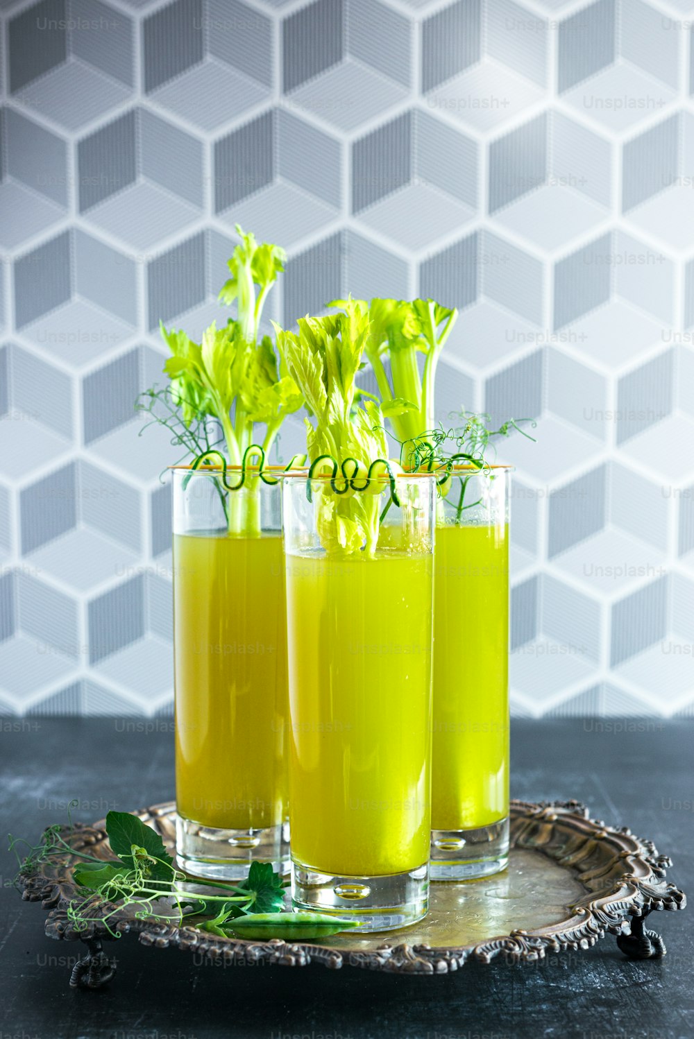 a couple of glasses filled with juice on top of a table