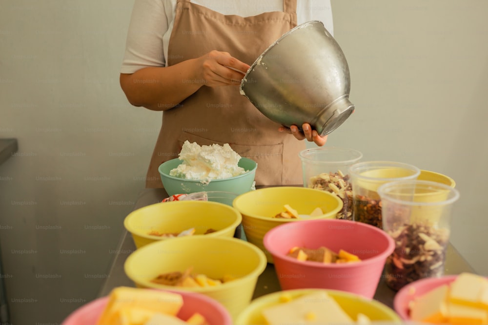 a woman in an apron pours a bowl of food