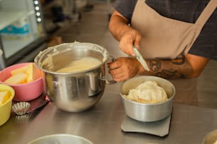 a man in an apron mixing food in a bowl