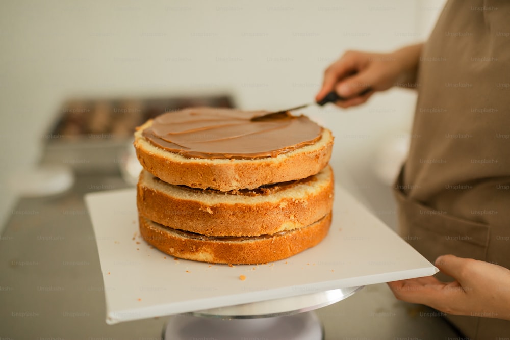 a person cutting a cake with a knife