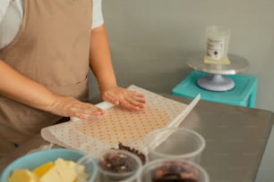 a woman in an apron preparing food on a counter