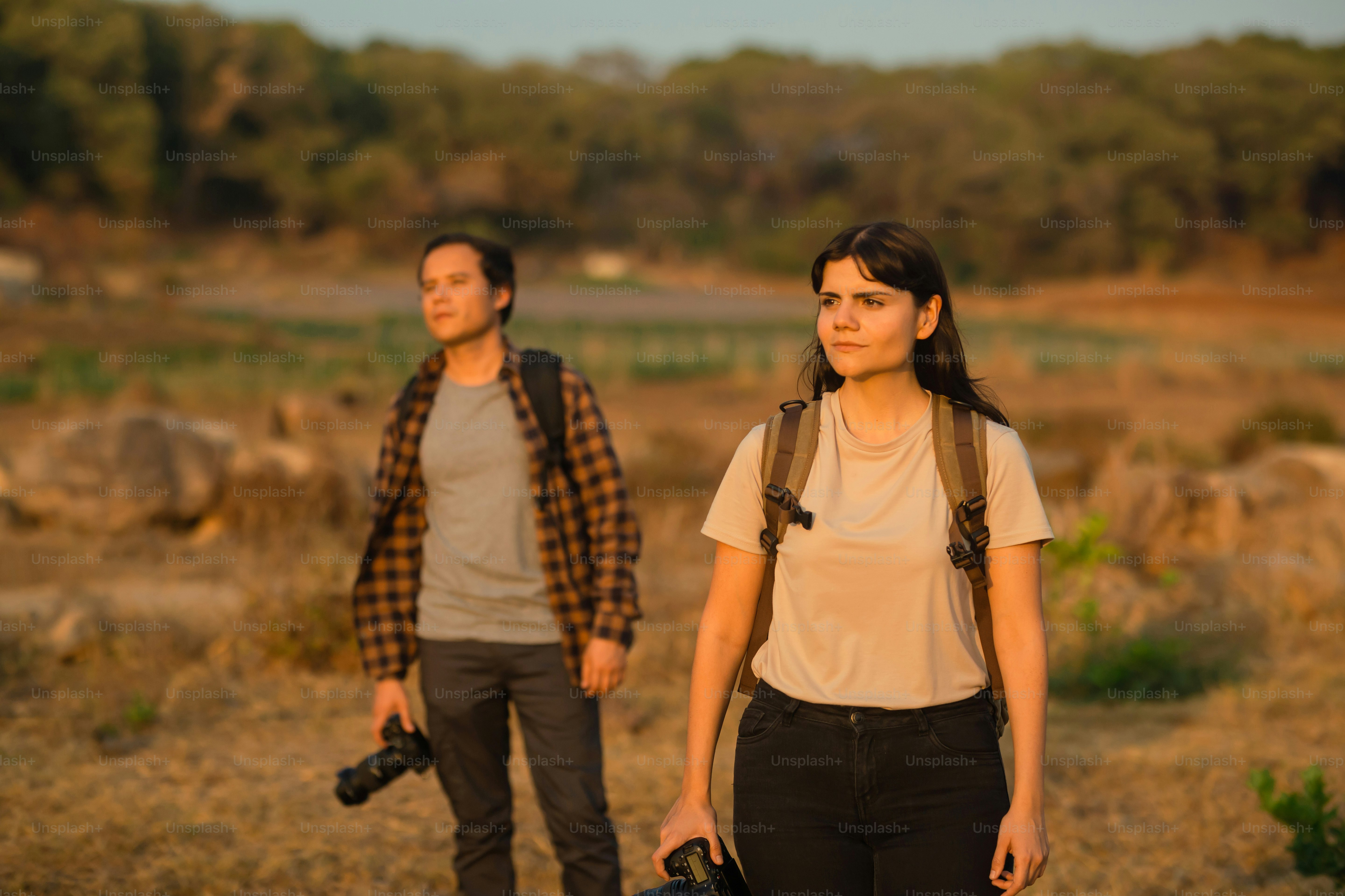 a man and a woman standing in a field