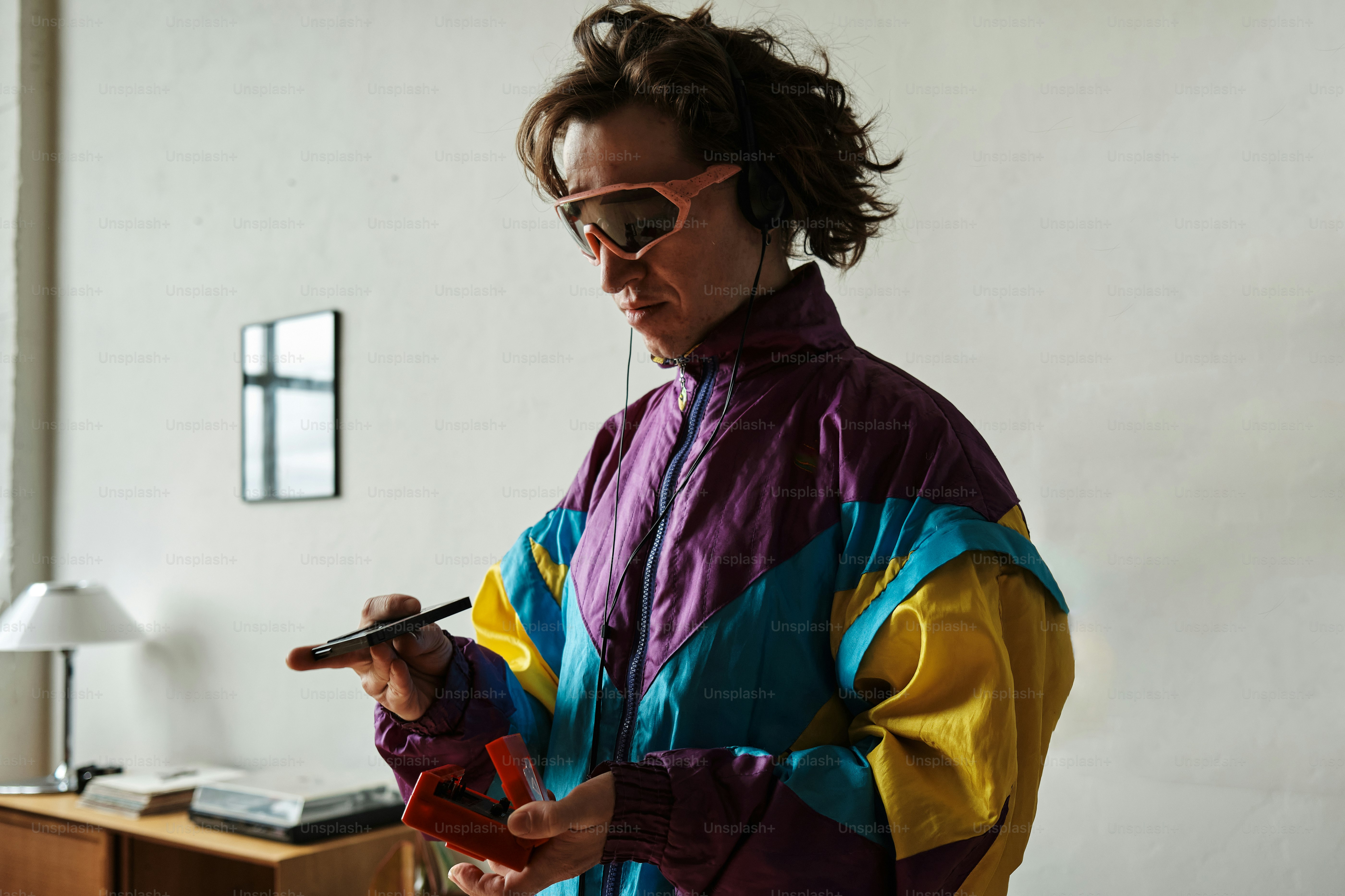 a woman in a colorful jacket holding a cell phone