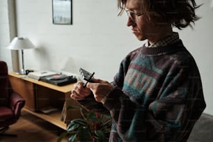 a woman standing in a living room holding a remote control